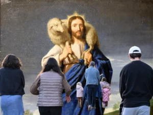 People admiring a painting of Jesus holding a sheep.